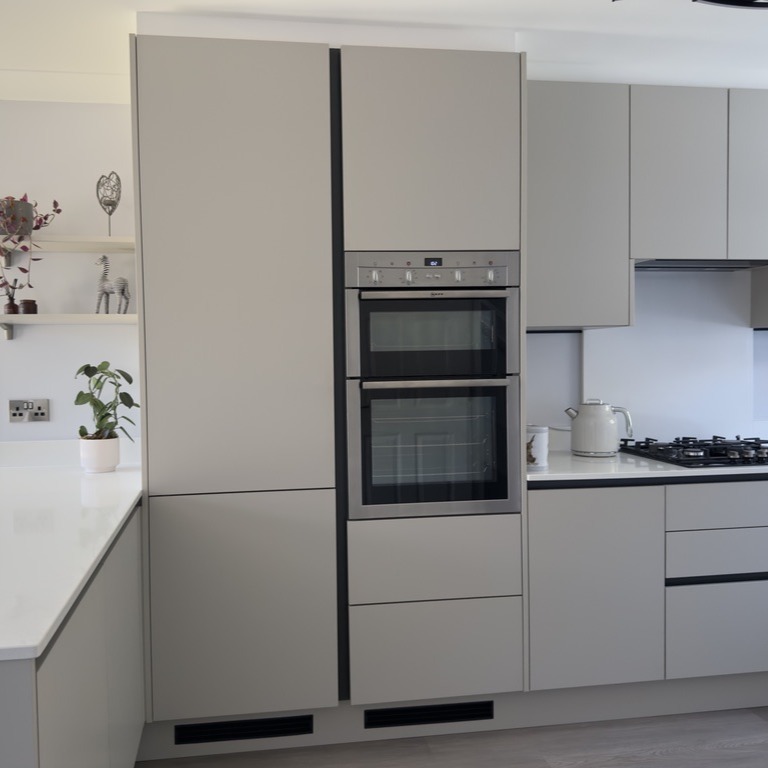 Small handleless kitchen with breakfast bar Milton Keynes Larder unit and integrated oven