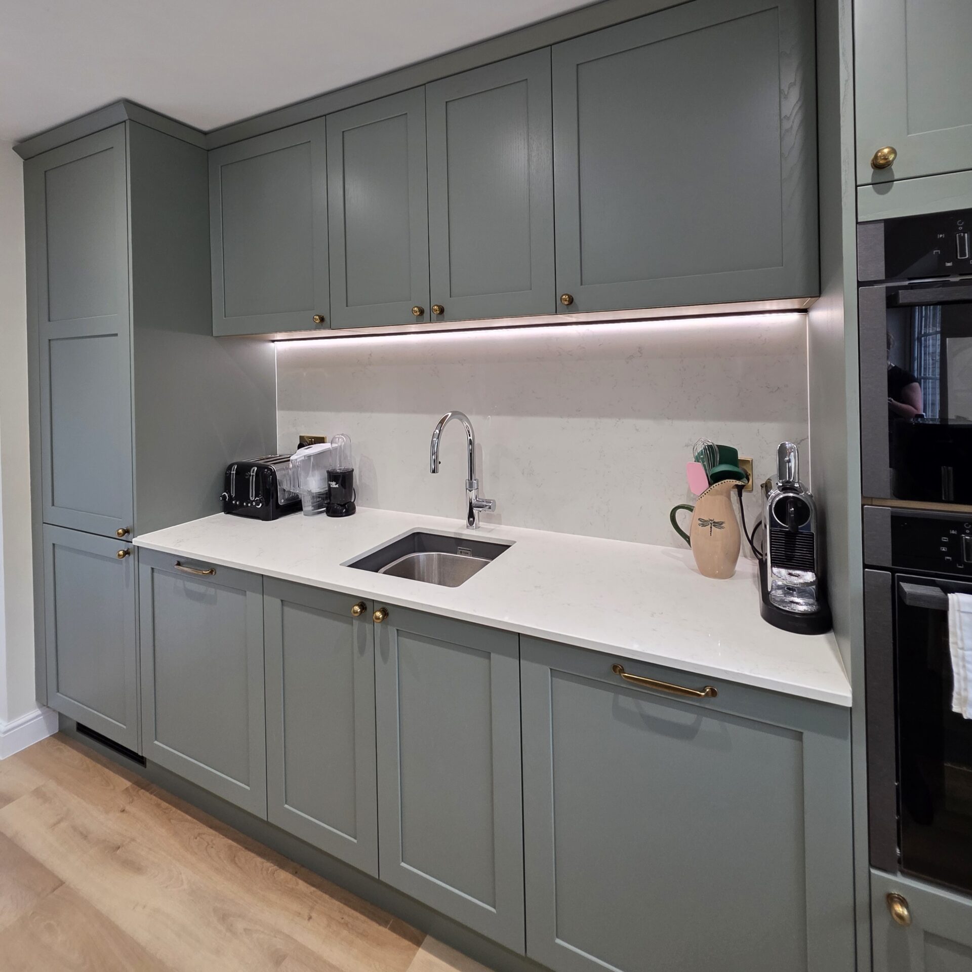 Kitchen Sink Area in sage green kitchen Sage green wall cupboard in shaker kitchen