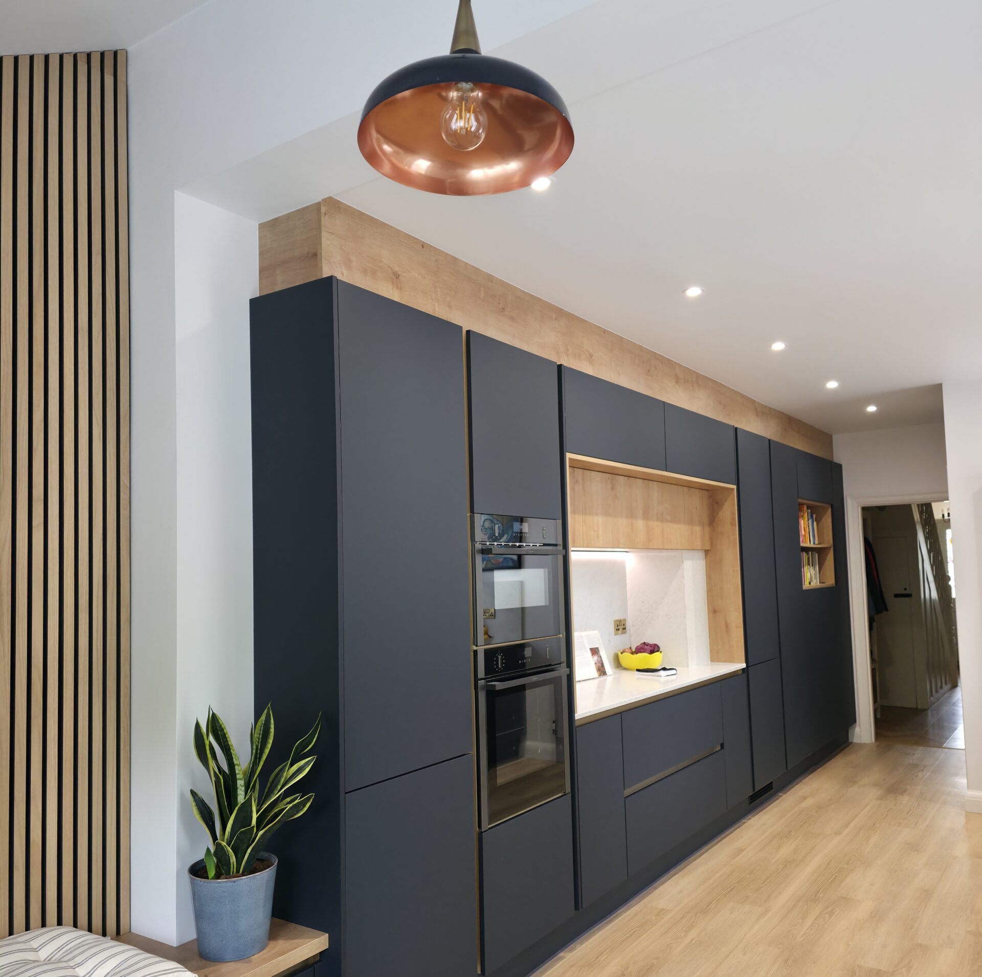Wall of units in a navy kitchen